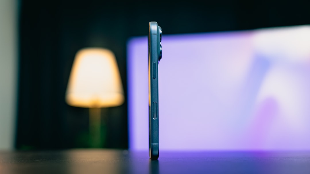 Side profile of a modern smartphone on a table.