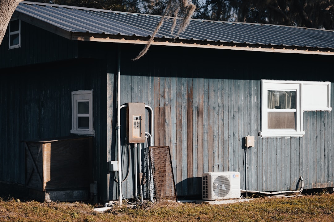 a small building with a gas pump next to it