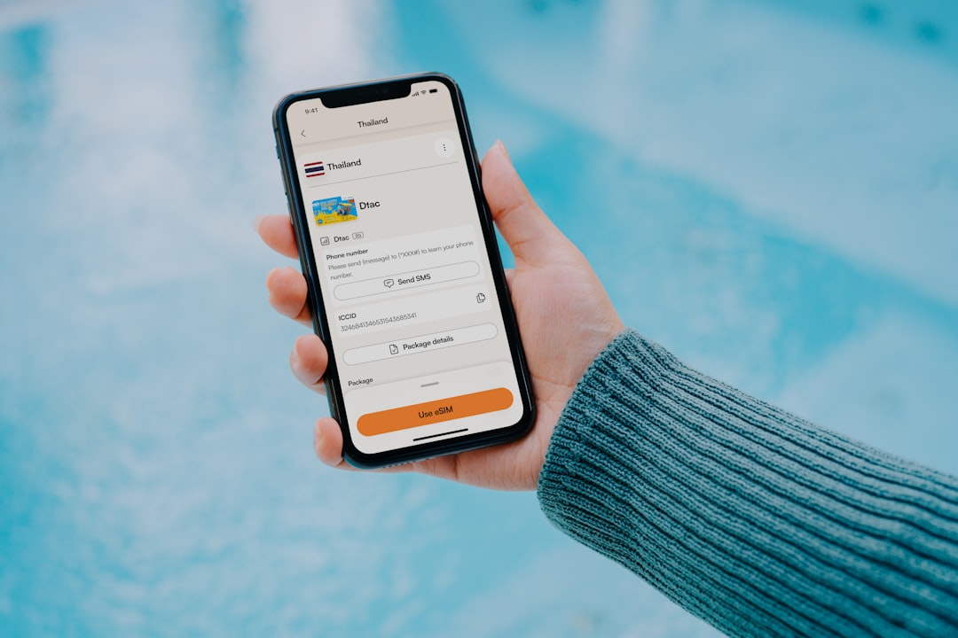 Hand holding smartphone with travel app open